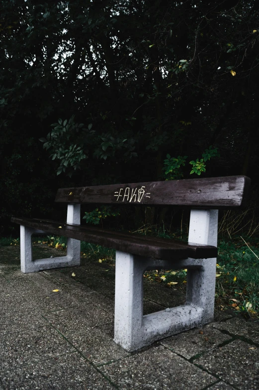 a concrete bench has the word shine written on it