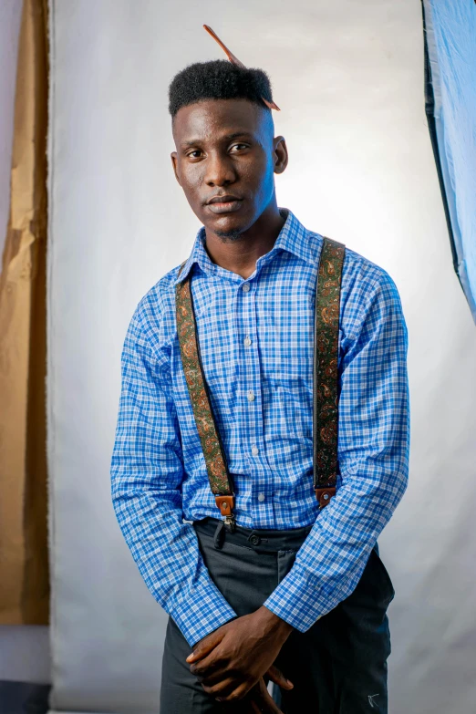 a man wearing a blue shirt holding an open camera bag