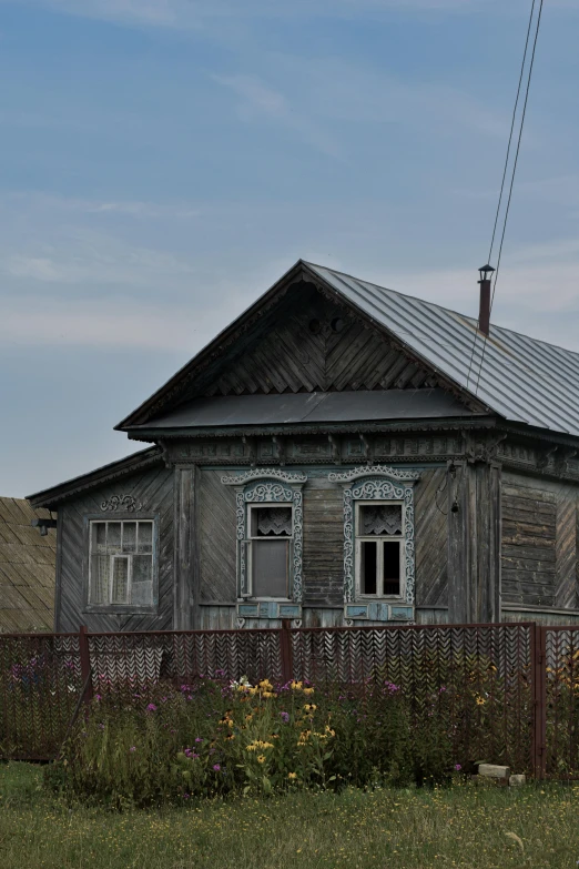 a wooden house with white windows on it