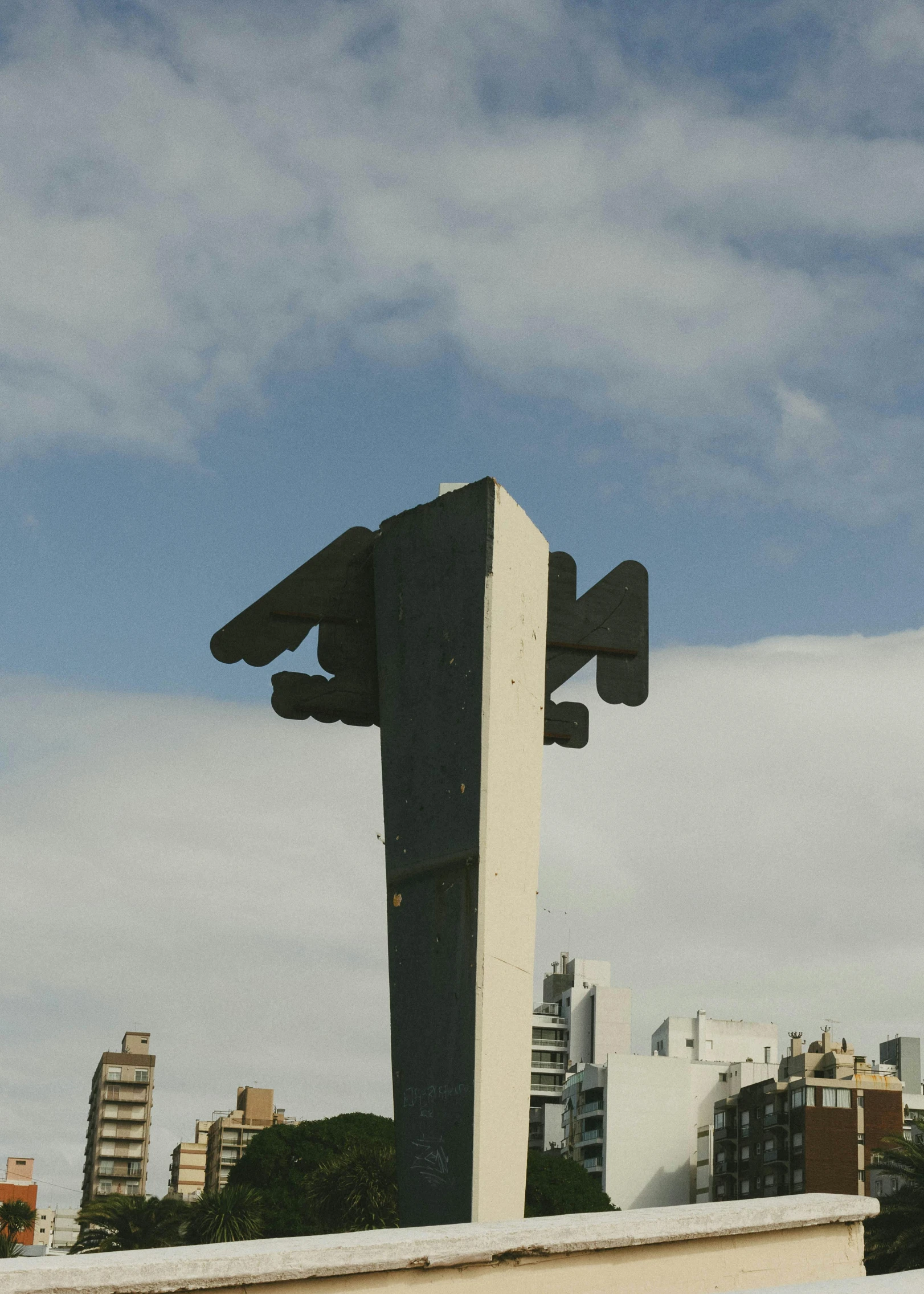 the back end of an airplane sculpture on a roof