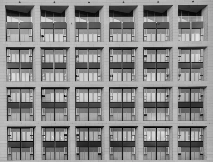 an old building has many windows, with balconies and shutters