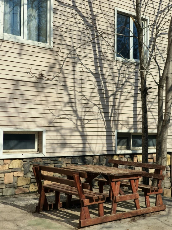 an empty picnic table in front of the building