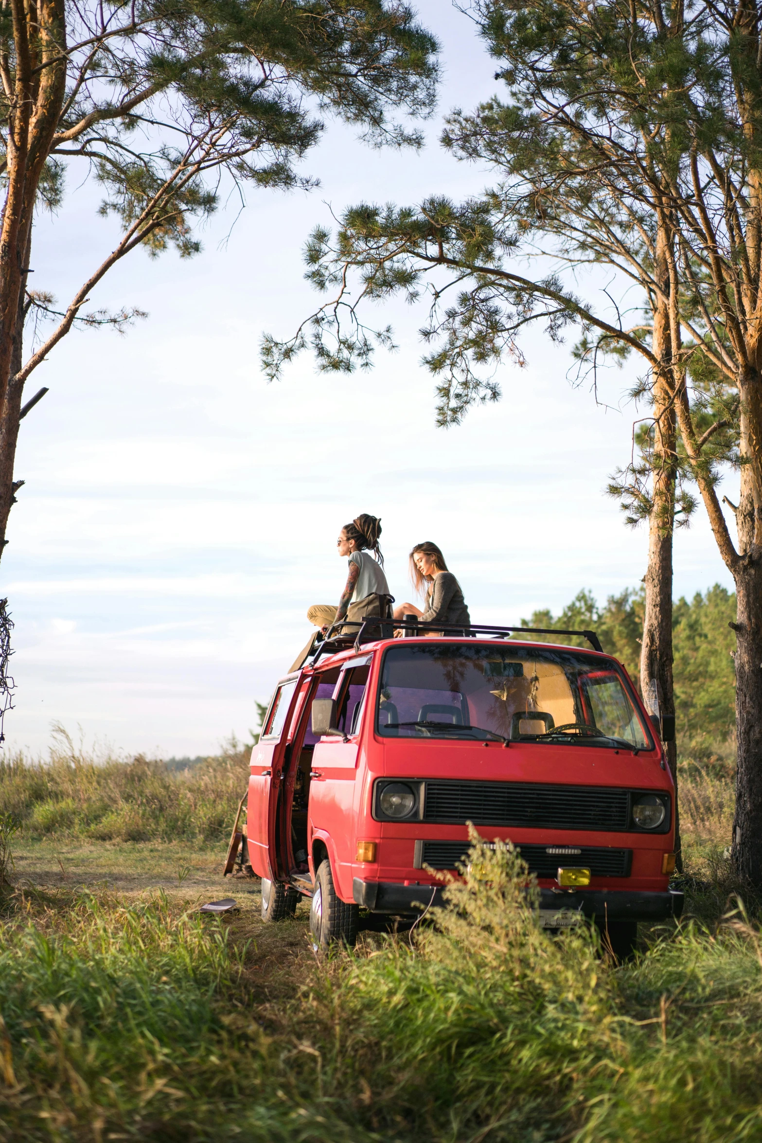 a couple are sitting in the back of a van