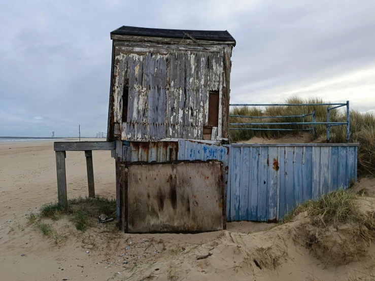 an old shed stands out against the desert