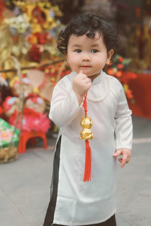 a small child wearing a traditional chinese dress