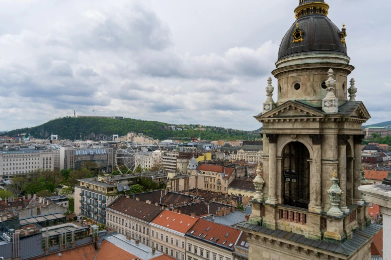 a tower with a clock on the top that sits in the middle of a city