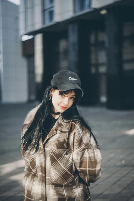 a woman with long hair wearing a baseball cap