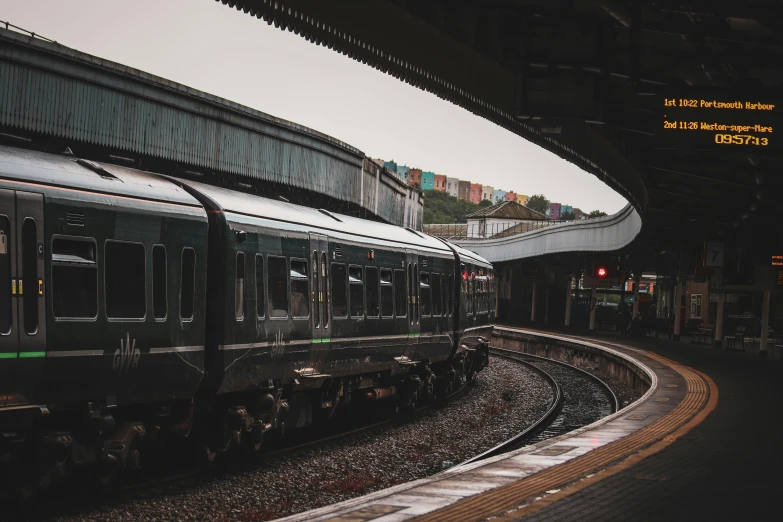 there is a black train pulled up to the train station