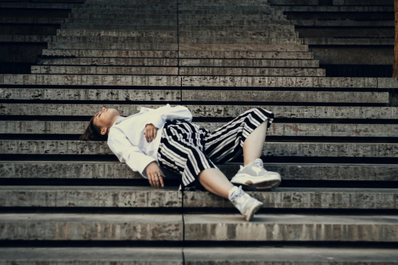 a woman lying on the steps next to her