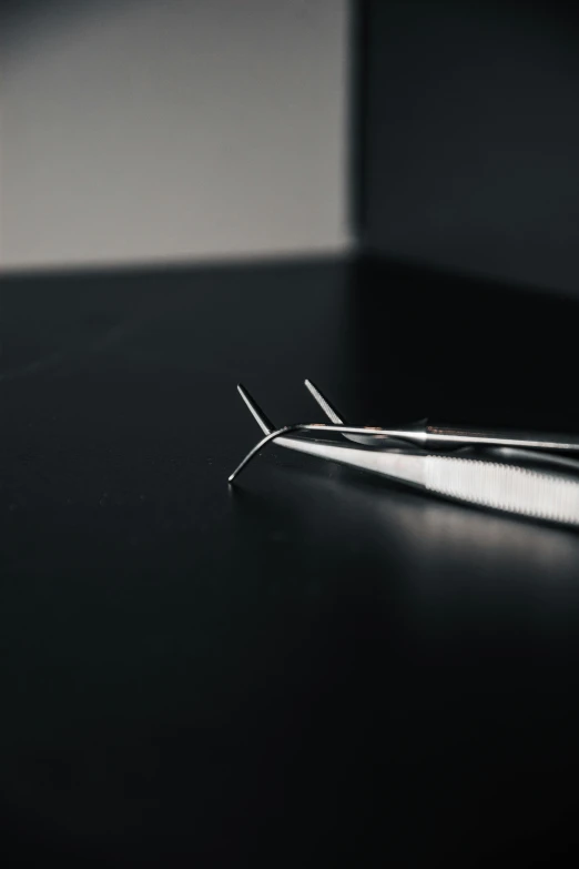 an instrument lying on top of a black table