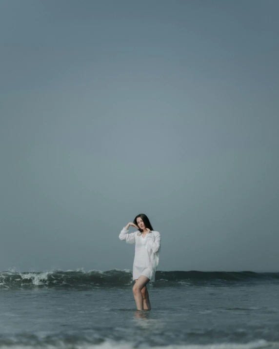 a woman standing in a body of water