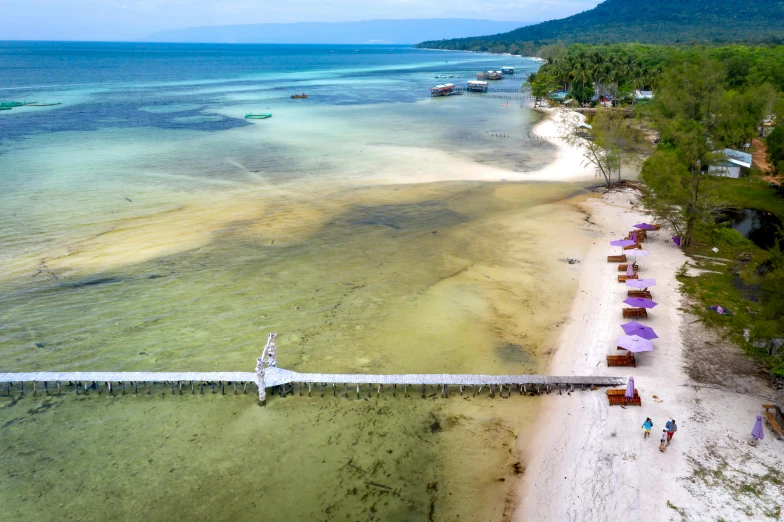 beach area with people standing on the shore