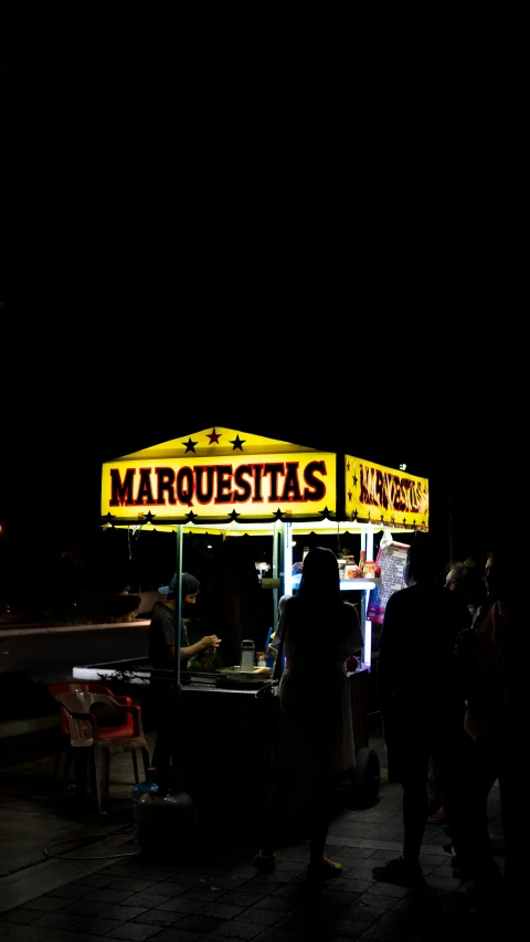 a dark po of a food vendor at night