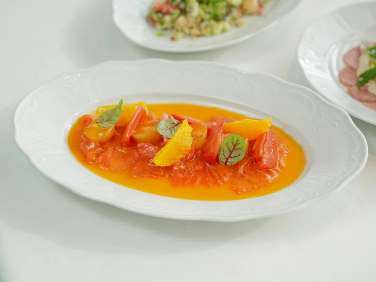 a table topped with plates and bowls filled with food