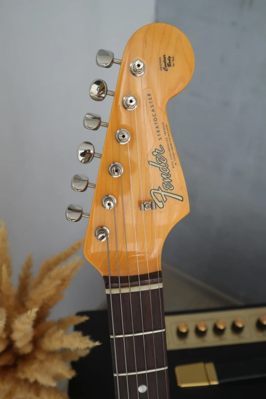 an electric guitar is standing upright on display