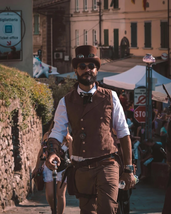 man in dress clothes walking through a town