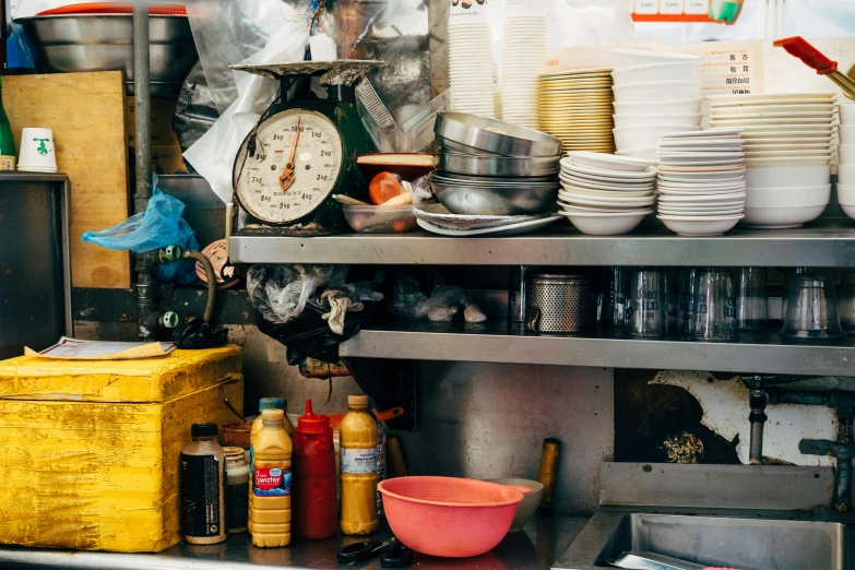 there are several different kinds of dishes on the shelf