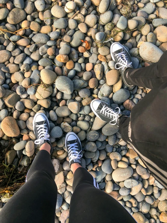 two men are standing in front of some rocks