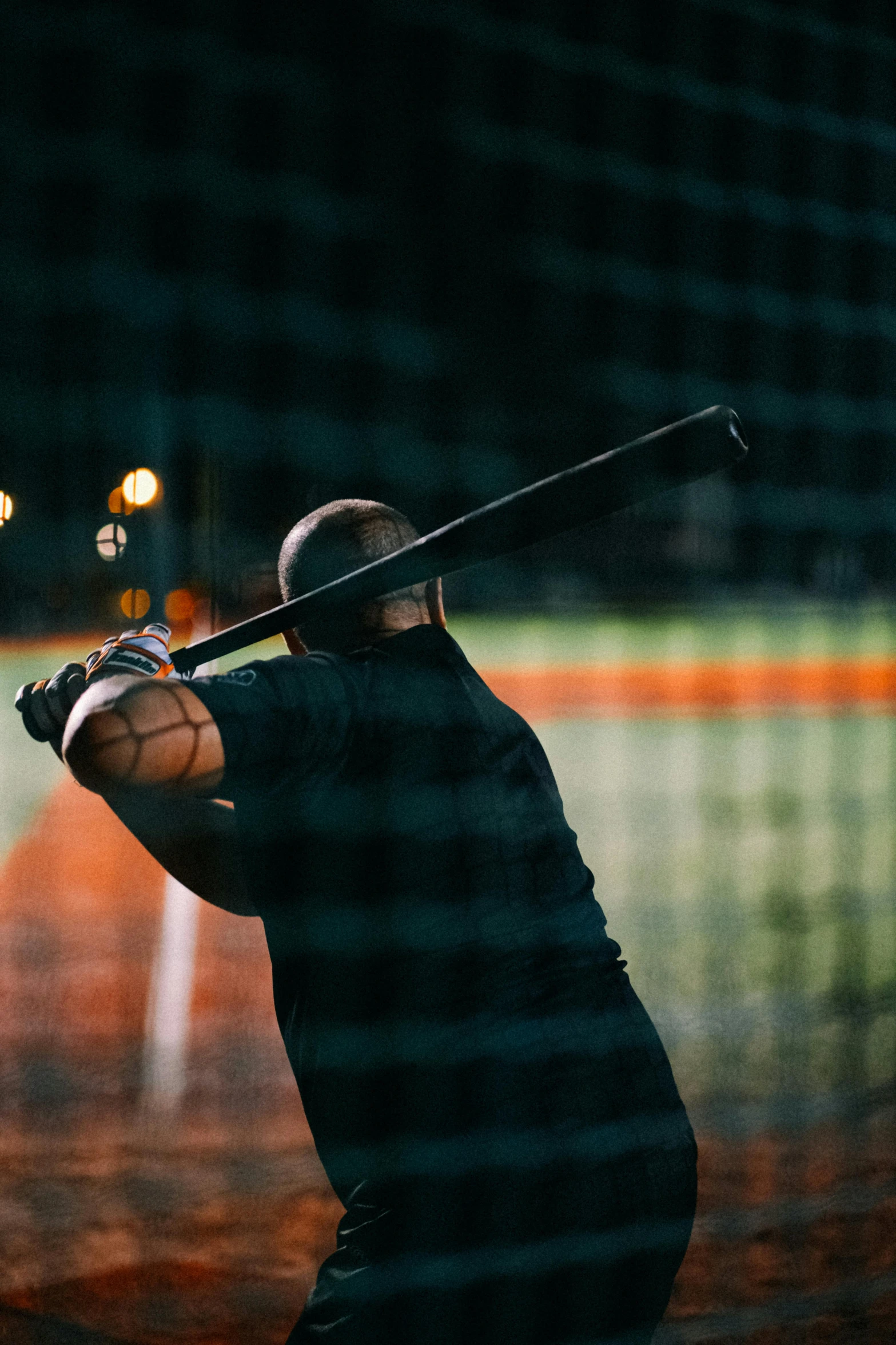 a baseball player standing with his bat back