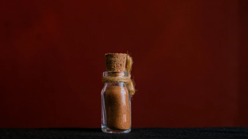 some kind of a brown substance in a glass bottle