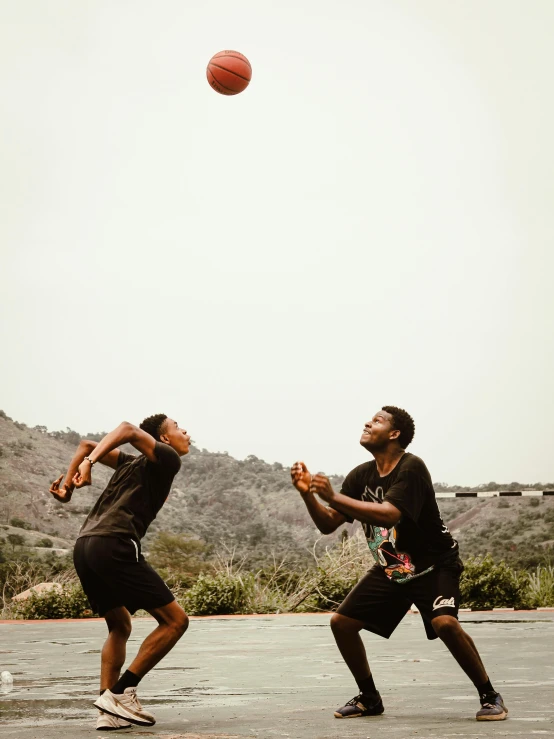 two young men play with an object in the air