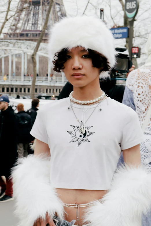 a model wears a pair of shorts and white fur hat