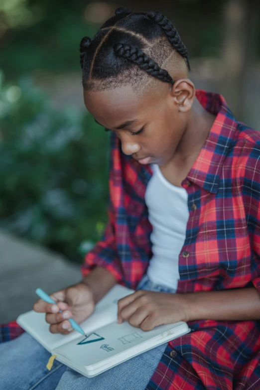 an african american girl sitting in a park