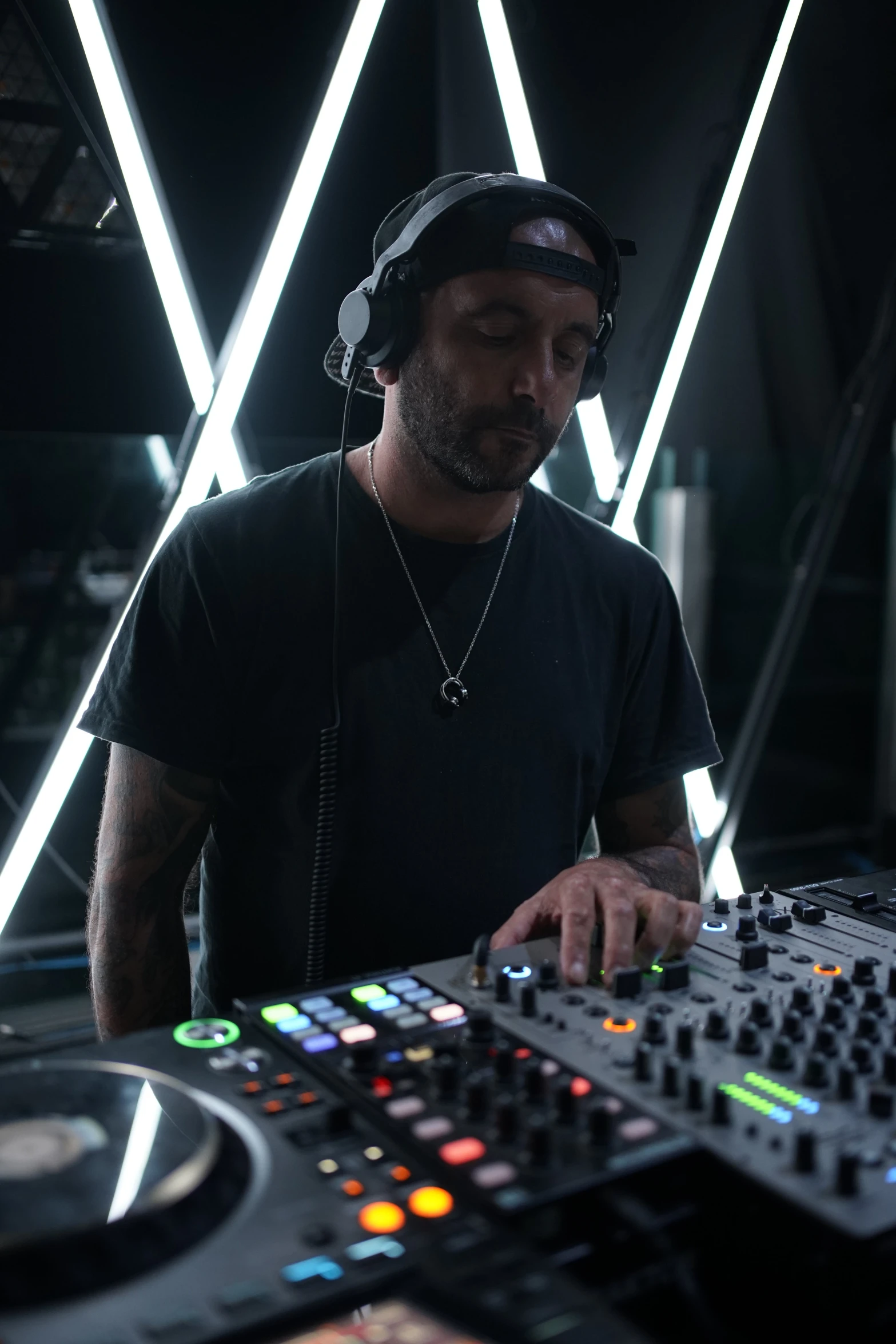 a man playing an electronic mixing console at a party