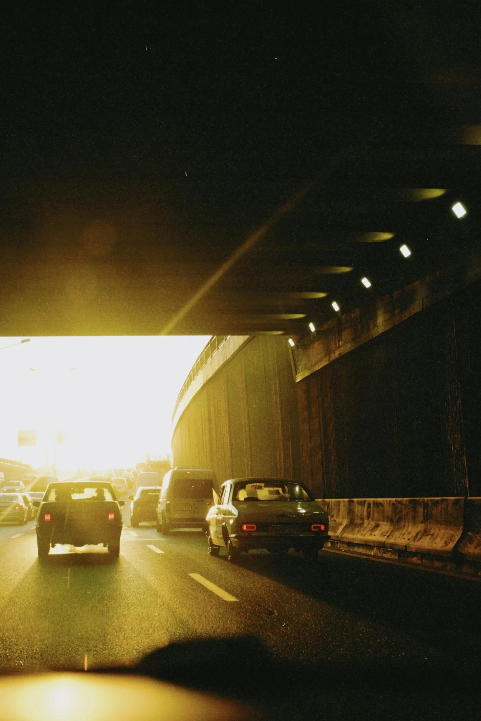 a car's back window is illuminated by the light of a street