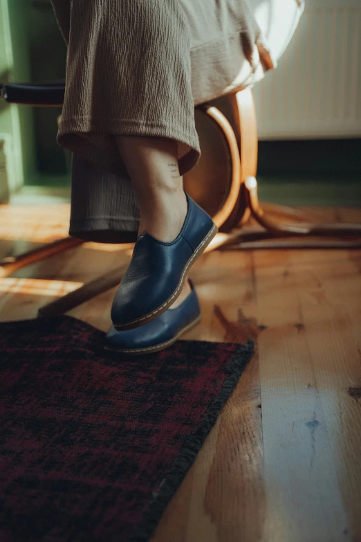 a person sitting in a chair on top of a rug