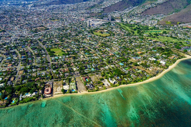 aerial view of ocean and city area near sandy beach