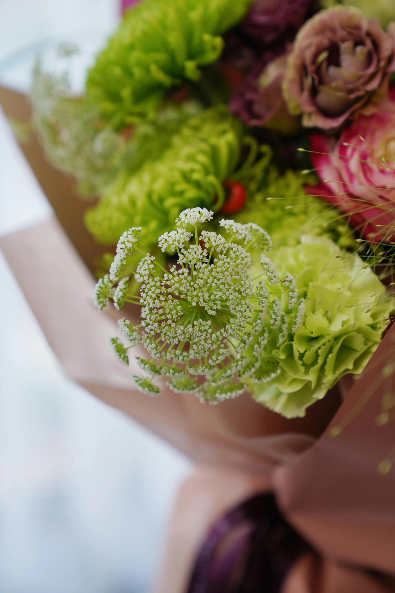 a bouquet of flowers in a vase with a ribbon tied around it