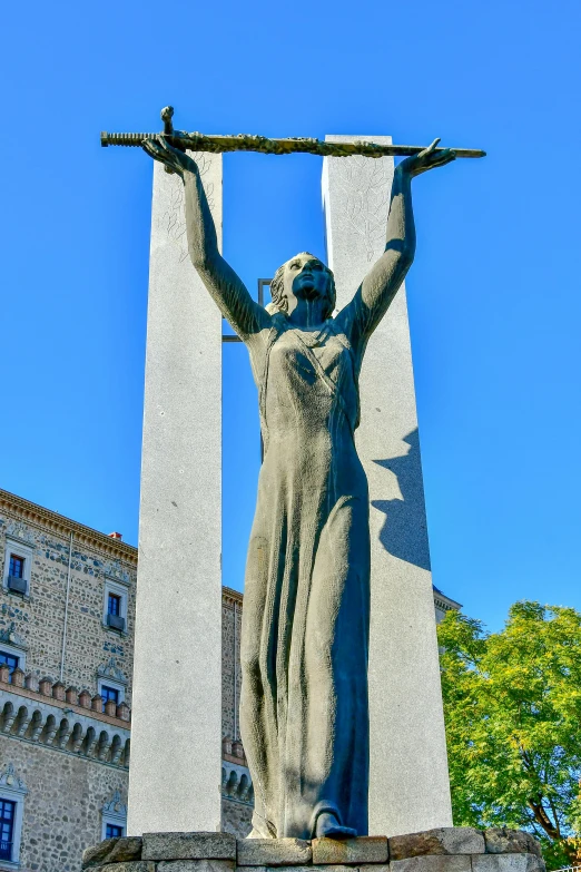 statue depicting mary and baby jesus in front of an old church