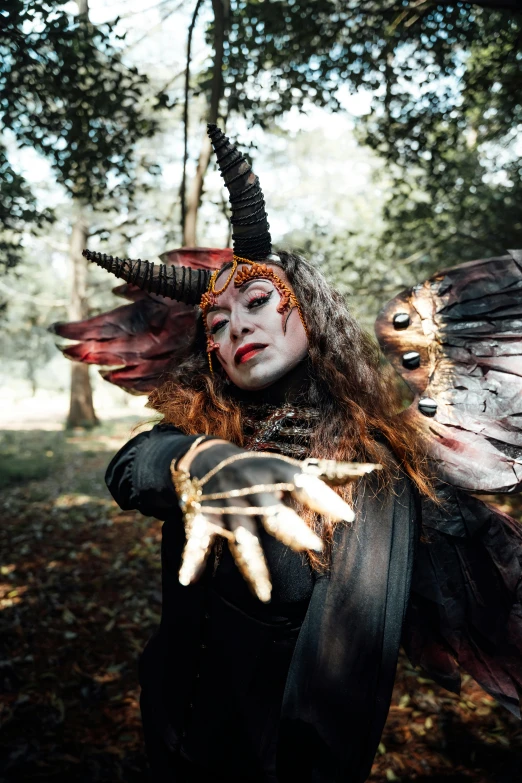 a woman with elaborate make up and horns