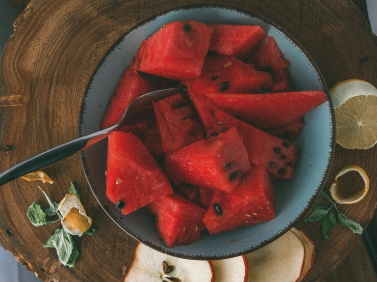 a plate filled with sliced watermelon and slices of bread