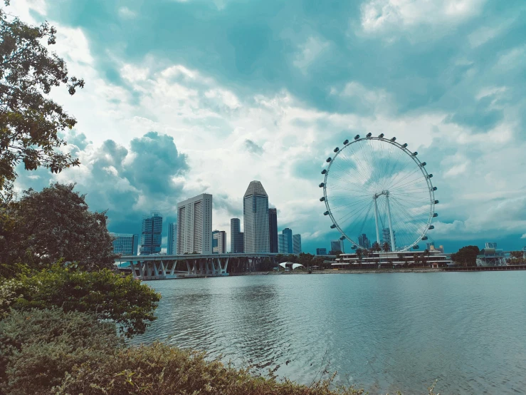 a river and an enormous wheel in the distance