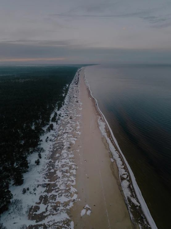 a beautiful long stretch of beach on a clear day