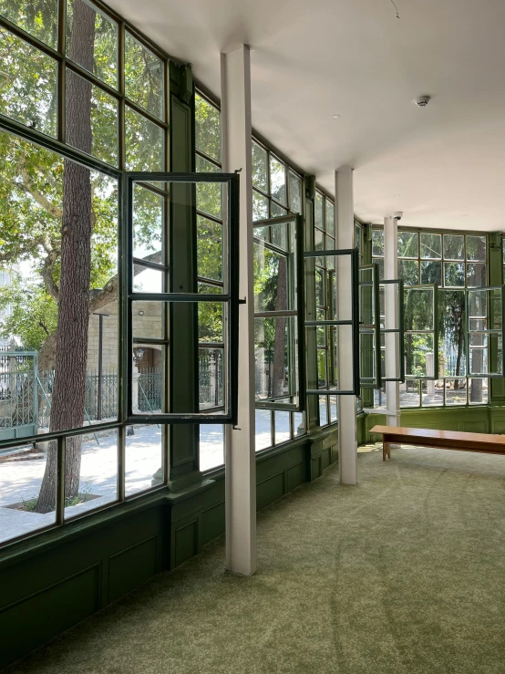 an empty building with green painted walls and windows