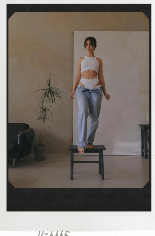 a woman is standing on a small stool