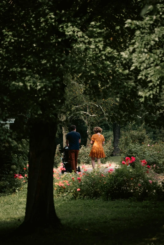 a man standing next to a woman in a garden