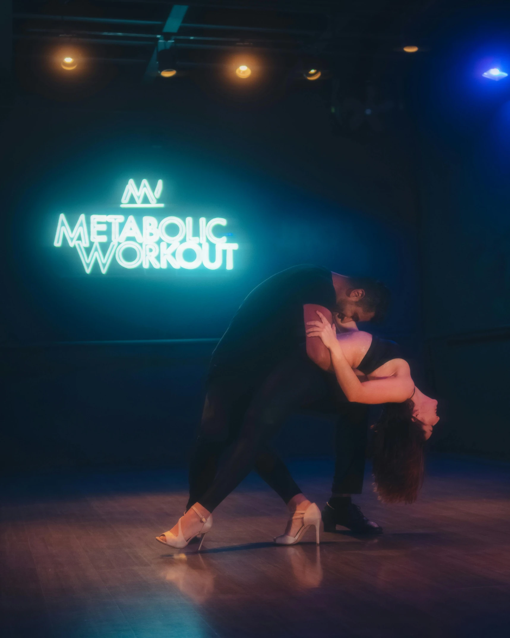 a man and a woman dance with the words mw metatronic workout above them