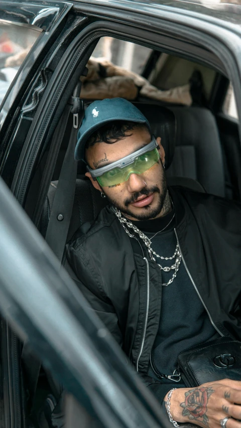 a man in a car with a blindfolded face