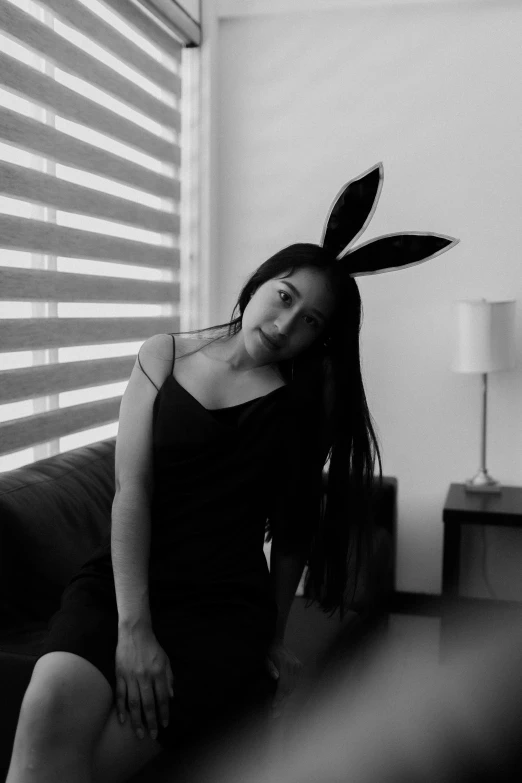 a person with a bunny ears sitting on a couch