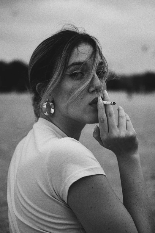 a black and white pograph of a woman smoking