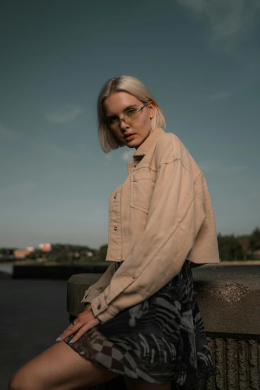 a woman is posing for the camera while leaning against a wall