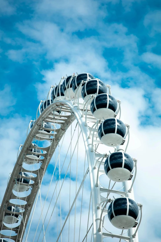 four tires are attached to the side of a large ferris wheel