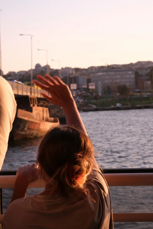 a woman that is sitting down on a rail