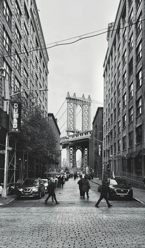 a group of people walking across a street