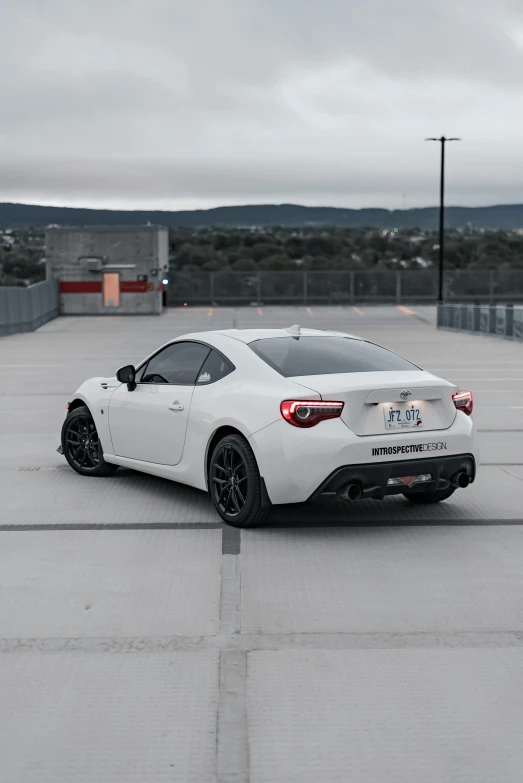 a sports car sitting in an empty lot