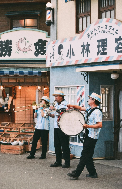 a man is holding a drum in front of some men